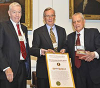 Photograph of Tom Starzl (right) being presented the Franklin Medal by Society President Clyde Barker (left) and Executive Officer Keith Thomson (center).